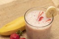 Banana Strawberry Milkshake. Glass cup on a wooden background. Homemade Royalty Free Stock Photo