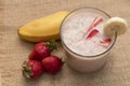 Banana Strawberry Milkshake. Glass cup on a wooden background. Homemade Royalty Free Stock Photo