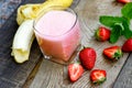 Banana - strawberry smoothie in glass (healthy vegetarian drink) Royalty Free Stock Photo