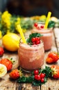 Banana and strawberry smoothie. Two Cold Strawberry Banana Smoothies in Glasses with Ingredients on Kitchen Table. Strawberry Royalty Free Stock Photo