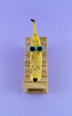 Banana with sunglasses resting on the wooden beach bed. Summer vacation concept on purple background Royalty Free Stock Photo