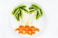 Banana tangerine kiwi palm tree on a white plate