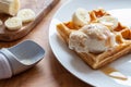 Banana waffle close-up. Delicious breakfast dessert meal prepared on plate