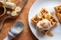 Banana waffles dessert with ice cream and maple syrup close-up Royalty Free Stock Photo