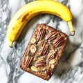 Banana and a walnut loaf of bread are on a marble counter Royalty Free Stock Photo