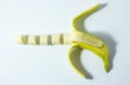 Banana on a white background in the form of a pistol
