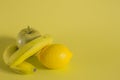 Bananas apple and lemon on yellow background Royalty Free Stock Photo