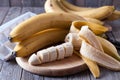 Bananas and banana slices on a wooden board Royalty Free Stock Photo