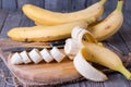 Bananas and banana slices on a wooden board Royalty Free Stock Photo