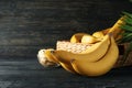 Bananas. Basket with bananas and bowl with slices on background Royalty Free Stock Photo