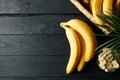 Bananas Basket with bananas and bowl with slices on wooden background Royalty Free Stock Photo