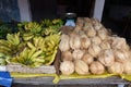 Bananas and coconuts on the counter at a local market of fruit and vegetable Royalty Free Stock Photo