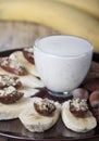 Bananas with dates and a cup of yogurt. Royalty Free Stock Photo