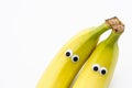 Bananas with googly eyes on white background