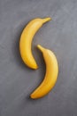 2 bananas on a gray background Royalty Free Stock Photo