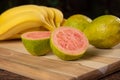 Bananas and guavas on polished wood, placed on rustic wood with selective focus