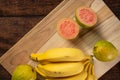 Bananas and guavas on polished wood, placed on rustic wood with Top view