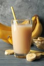 Bananas and juice against gray background Fresh fruit Royalty Free Stock Photo