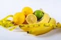 The concept of healthy eating, weight loss, . Bananas, lemon, measuring tape on the table