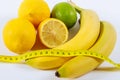 The concept of healthy eating, weight loss, . Bananas, lemon, measuring tape on the table