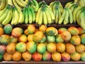 Bananas and mango for sale on farmers market Royalty Free Stock Photo