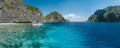 Banca boat moored near limestone rocks of Matinloc island, highlights of hopping trip Tour C. Most beautiful place at Marine Royalty Free Stock Photo