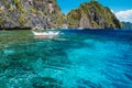 Banca boat moored und crystal clear ocean water near Matinloc island, highlights of hopping trip Tour C. Most beautiful place at Royalty Free Stock Photo