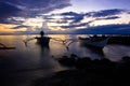 Banca boat at sunset on the beach