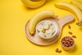 A banch of bananas with almonds on yellow background. Royalty Free Stock Photo