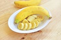 A banch of bananas in a bowl over a wooden t Royalty Free Stock Photo