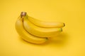 A banch of bananas on yellow background. Royalty Free Stock Photo