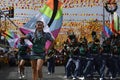 Band majorettes perform flag waving dancing skills on street during the annual brass band exhibition