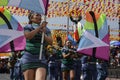 Band majorettes perform flag waving dancing skills on street during the annual brass band exhibition