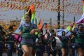 Band majorettes perform flag waving dancing skills on street during the annual brass band exhibition