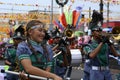 Band majorettes perform flag waving dancing skills on street during the annual brass band exhibition