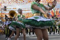 Band majorettes perform flag waving dancing skills on street during the annual brass band exhibition