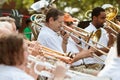 Band Members Play Trombones And Trumpets At Small Town Parade