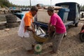 Fishermen place a basket full of fish on a scale, Banda Aceh, Sumatra