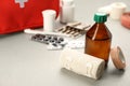 Bandage, sticking plaster roll and medical alcohol on grey table, space for text. First aid kit Royalty Free Stock Photo