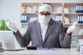 Bandaged businessman worker working in the office doing paperwor