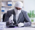 Bandaged businessman worker working in the office doing paperwor