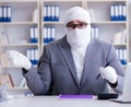 Bandaged businessman worker working in the office doing paperwor