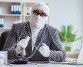 Bandaged businessman worker working in the office doing paperwor