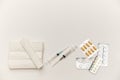 Bandages, syringes, pills, pills and vitamins on a white background, top view. Concept of first aid kit. White Royalty Free Stock Photo