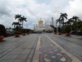 Pedestrian street with palm trees in front of the Sultan Omar Ali Saifuddin Mosque in Brunei Royalty Free Stock Photo