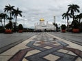 Street with palm trees in front of the Sultan Omar Ali Saifuddin Mosque in Brunei Royalty Free Stock Photo