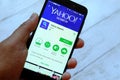 BANDAR SERI BEGAWAN,BRUNEI - JULY 25TH,2018 : A male hand holding smartphone with Yahoo Search app on android Google Play Store