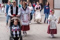 People in traditional holiday peasant huertano clothes walking in the street during the spring festival of Bando de la Huerta in
