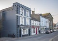 BANDON, COUNTY CORK, IRELAND. MARCH 29, 2022. Facades of small offices and cafe. Street view to small town