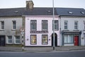 BANDON, COUNTY CORK, IRELAND. MARCH 29, 2022. Facades of small offices and cafe. Street view to small town